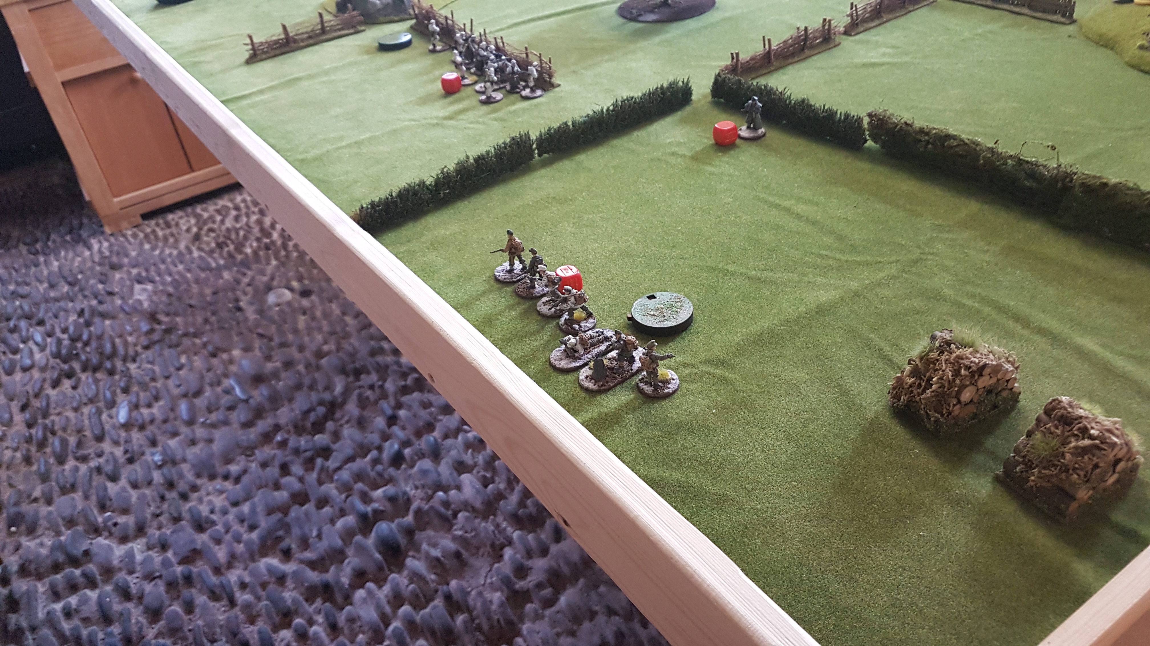 The continued fire on the German left flank results the German section breaking and moving back towards the rear edge of the table.