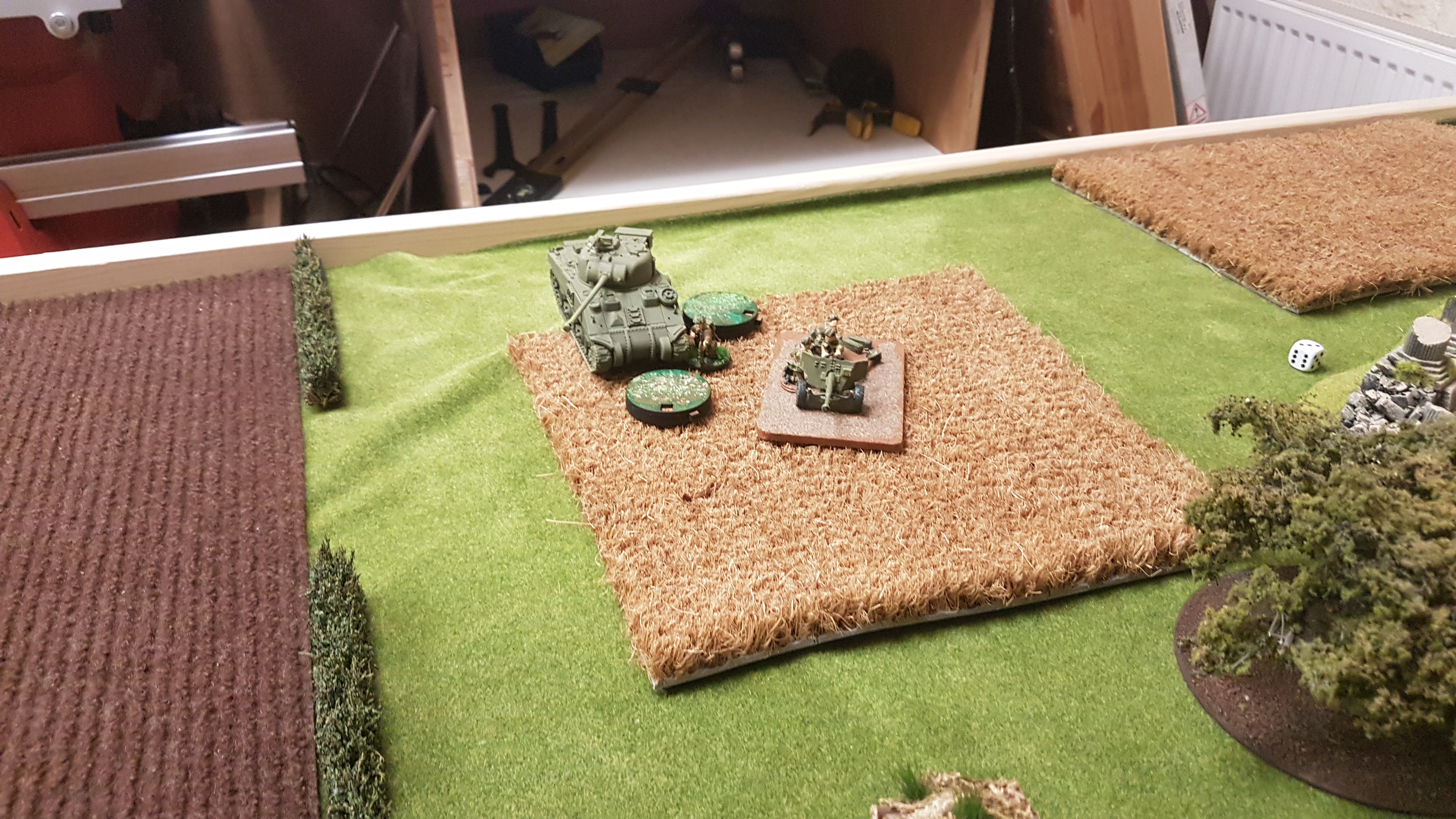 The 17 pounder and the Sherman fire in to the German infantry.  The Sherman's turret may jammed but it's gun is pointed in the right direction, for the British that is!