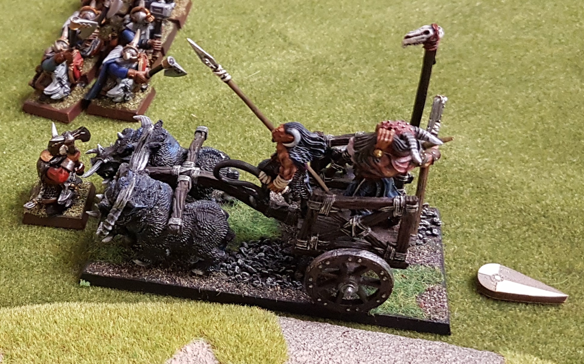 A beastly chariot charges Dwarven Hearthguard!
