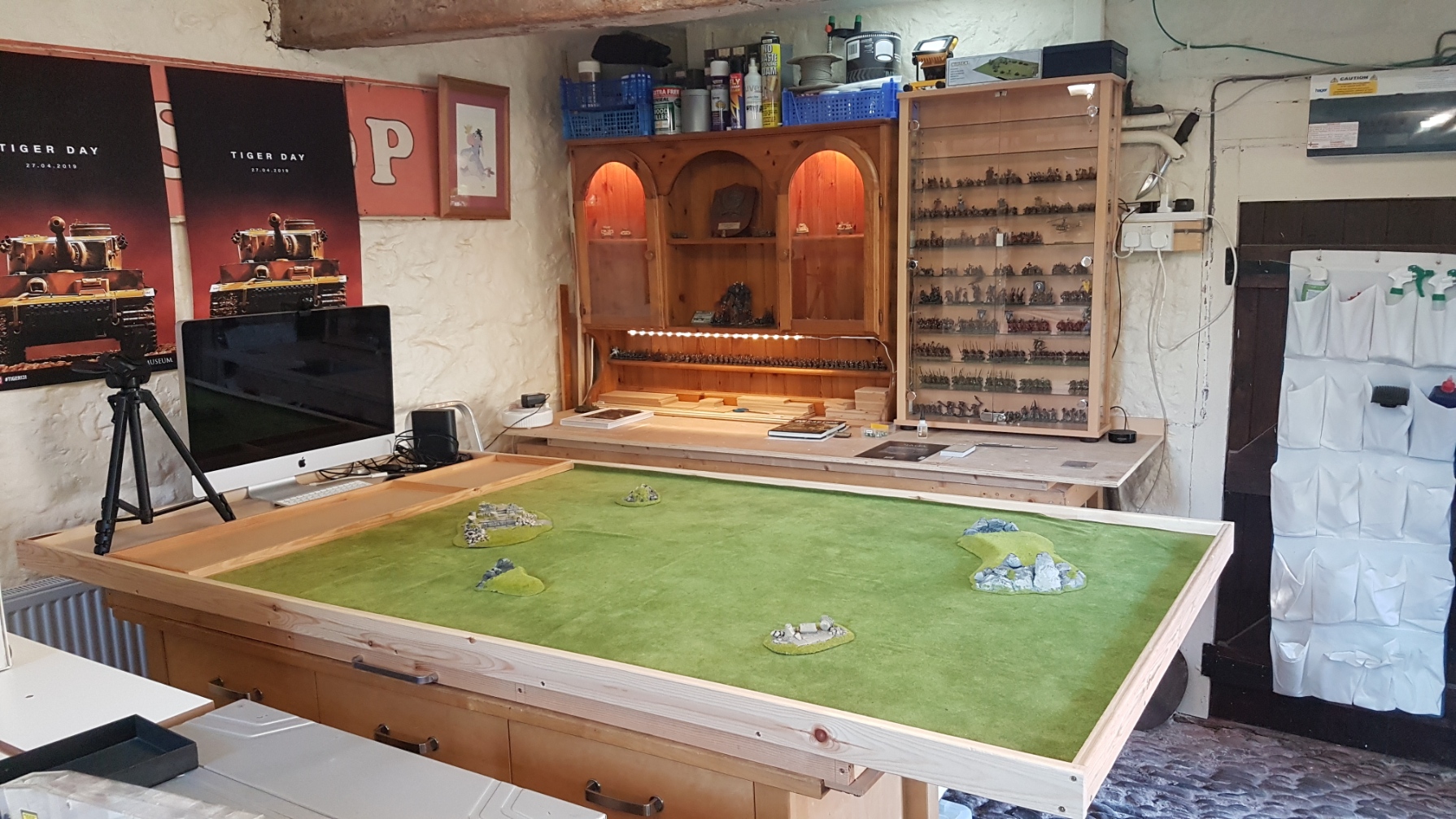 The second eight by four table with figure display cabinets in the background.  This table is hinged so that it can tilted, allowing more access space by workbench as and when needed.