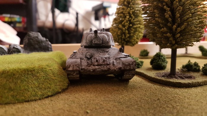 A T-34 appears in the edge of the wood to the North West of the village